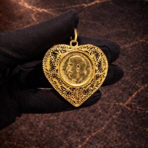 Begagnad guldmynt med ram i 21K - 14,92g